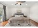 Inviting bedroom featuring a king-sized bed, a ceiling fan, and a view of the outside at 3308 Middlesex Rd, Orlando, FL 32803