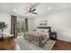 Serene main bedroom with hardwood floors, a cozy bed, and a window view to the outside at 3308 Middlesex Rd, Orlando, FL 32803