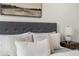 A detailed shot of a made bed with several pillows and a nightstand holding a lamp at 3308 Middlesex Rd, Orlando, FL 32803