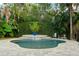 Lush backyard showcasing a refreshing pool with a waterfall feature and tropical landscaping at 3308 Middlesex Rd, Orlando, FL 32803