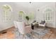 Sunlit sitting room featuring arched windows, plantation shutters, and comfortable seating arrangement at 3308 Middlesex Rd, Orlando, FL 32803