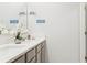 Bathroom featuring double sink vanity with modern decor at 4589 Boxwood Way, Mount Dora, FL 32757