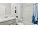 Well-lit bathroom featuring a combined shower and bathtub and a gray vanity with white countertop at 4589 Boxwood Way, Mount Dora, FL 32757