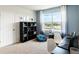 Bedroom with large window, black shelving unit, and a blue beanbag chair at 4589 Boxwood Way, Mount Dora, FL 32757