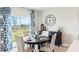 Dining area with round wooden table and sliding glass doors providing natural light and scenic views at 4589 Boxwood Way, Mount Dora, FL 32757