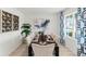 Elegant dining room with a large table, tufted chairs, and modern decor at 4589 Boxwood Way, Mount Dora, FL 32757
