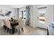 Bright dining area featuring a modern table and chairs with large window views at 4589 Boxwood Way, Mount Dora, FL 32757