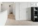Bright upstairs hallway featuring neutral colored carpet and doors with white trim at 4589 Boxwood Way, Mount Dora, FL 32757