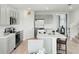 Modern kitchen equipped with stainless steel appliances, sleek cabinetry, and a center island with bar seating at 4589 Boxwood Way, Mount Dora, FL 32757