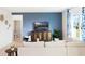 Comfortable living room with a blue accent wall, decorative console, and a view of the bathroom at 4589 Boxwood Way, Mount Dora, FL 32757