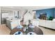 Open-concept living area showcasing a modern kitchen, dining space, and a cozy seating area with a blue accent wall at 4589 Boxwood Way, Mount Dora, FL 32757