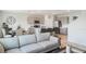 Bright, open-concept living space with modern kitchen featuring stainless steel appliances and light gray cabinets at 4589 Boxwood Way, Mount Dora, FL 32757
