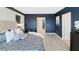 Comfortable main bedroom with patterned blue bedding, white pillows, and an accent wall at 4589 Boxwood Way, Mount Dora, FL 32757