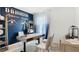 Bright office space showcasing modern decor with a blue accent wall and stylish furniture at 4589 Boxwood Way, Mount Dora, FL 32757