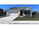 Charming single-Gathering home featuring a two-car garage, neutral tones, and well-maintained landscaping at 4597 Boxwood Way, Mount Dora, FL 32757