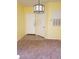 Bright entryway featuring neutral colors and a decorative light fixture, adjacent to a carpeted living area at 5455 Vineland Rd # 3303, Orlando, FL 32811