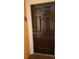 A close-up of the solid, dark brown front door of the residence with the unit number clearly visible at 5455 Vineland Rd # 3303, Orlando, FL 32811