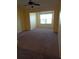 Sunlit living room with carpeted floors and a large window, providing a cozy and inviting atmosphere at 5455 Vineland Rd # 3303, Orlando, FL 32811
