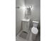 Cozy bathroom featuring a toilet, mirror, and sink at 5616 Clearview Dr, Orlando, FL 32819
