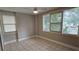 Bright bedroom with multiple windows, neutral walls, and tile flooring at 5616 Clearview Dr, Orlando, FL 32819
