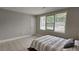 Bright bedroom featuring neutral walls and window with backyard view at 5616 Clearview Dr, Orlando, FL 32819