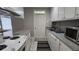 Clean kitchen with white cabinets, gray counters, stainless steel microwave, and modern appliances at 5616 Clearview Dr, Orlando, FL 32819