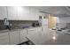 Bright kitchen with stainless steel sink, white cabinets, and a full suite of appliances at 5616 Clearview Dr, Orlando, FL 32819