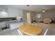 Open living room with a dining area and partial kitchen view with white cabinets at 5616 Clearview Dr, Orlando, FL 32819