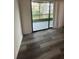 View of the balcony with sliding glass doors and wood-look vinyl flooring at 5951 Village Cir # Ge, Orlando, FL 32822