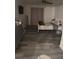 Cozy bedroom with a bed, dresser, mirror and neutral gray wood-style flooring at 5951 Village Cir # Ge, Orlando, FL 32822