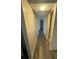 Hallway with grey flooring that leads into the bathroom at 5951 Village Cir # Ge, Orlando, FL 32822