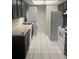 Updated kitchen featuring a stackable washer/dryer and white appliances at 5951 Village Cir # Ge, Orlando, FL 32822