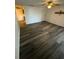 Living room with wood-look flooring and open layout, next to the dining area at 5951 Village Cir # Ge, Orlando, FL 32822