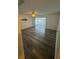 View of the living room with a sliding glass door, ceiling fan and vinyl wood flooring at 5951 Village Cir # Ge, Orlando, FL 32822