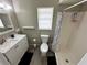 Bright bathroom includes a shower, toilet, vanity, and window, providing a functional and well-lit space at 76 Windtree Ln # 201, Winter Garden, FL 34787