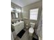 Bathroom featuring gray walls, a white vanity, and wood look floors creating a calm and modern atmosphere at 76 Windtree Ln # 201, Winter Garden, FL 34787