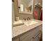 Bathroom vanity with white cabinetry, granite countertops, and brushed nickel faucet at 76 Windtree Ln # 201, Winter Garden, FL 34787