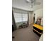 Bedroom with carpet, a ceiling fan, and large window at 76 Windtree Ln # 201, Winter Garden, FL 34787