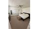 Bright bedroom with neutral tones, featuring carpet flooring, ample closet space, and access to an en-suite bathroom at 76 Windtree Ln # 201, Winter Garden, FL 34787