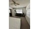 Bedroom with neutral carpeting, a ceiling fan, a dresser, and a large window at 76 Windtree Ln # 201, Winter Garden, FL 34787