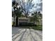 Entrance to the Windtree Gardens community featuring lush landscaping and palm trees at 76 Windtree Ln # 201, Winter Garden, FL 34787