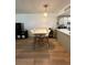 Eat-in kitchen with sleek white cabinetry, countertops, and stainless steel appliances at 76 Windtree Ln # 201, Winter Garden, FL 34787