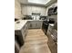 Modern kitchen featuring white countertops, stainless steel appliances and ample lighting at 76 Windtree Ln # 201, Winter Garden, FL 34787