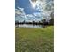 Scenic view of the community pond, with lush green lawn, featuring a fountain at 76 Windtree Ln # 201, Winter Garden, FL 34787