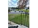 Scenic view from the condo stairs, overlooking a parking area, landscaping and a peaceful pond at 76 Windtree Ln # 201, Winter Garden, FL 34787
