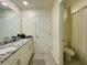 Bathroom features double sink vanity with granite countertop, and tile flooring with separate toilet and shower area at 8949 Coconut Breeze Dr, Kissimmee, FL 34747