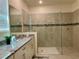 Modern bathroom features granite countertops, a glass-enclosed shower, and stylish fixtures at 8949 Coconut Breeze Dr, Kissimmee, FL 34747