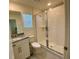 Well-lit bathroom features a glass-enclosed shower and modern vanity at 8949 Coconut Breeze Dr, Kissimmee, FL 34747