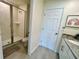 Clean bathroom featuring a glass-enclosed shower and modern vanity with stone countertop at 8949 Coconut Breeze Dr, Kissimmee, FL 34747