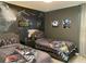 Themed bedroom features two beds with themed bedding, custom wall art, and carpeted flooring at 8949 Coconut Breeze Dr, Kissimmee, FL 34747